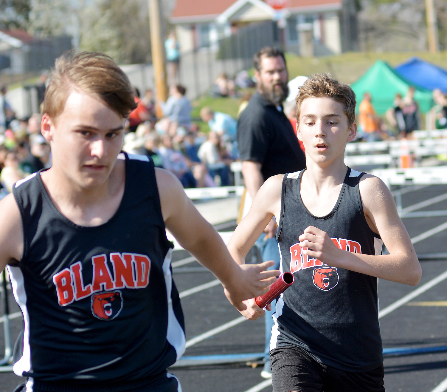 Miles Frey (far left) reaches back for the baton from Malachi Fredendall for Bland’s Bears during the boys 4x800-meter relay during the Vienna Middle School (VMS) Eagle Classic held at Vienna High School’s track.